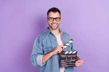 Photo portrait male director keeping clapboard making movie isolated pastel violet color background
