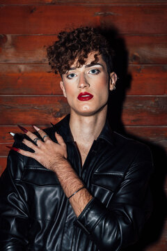 Sensual gay in stylish apparel with makeup