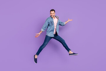 Fototapeta na wymiar Full length body size photo man smiling jumping high cheerful funky isolated pastel violet color background