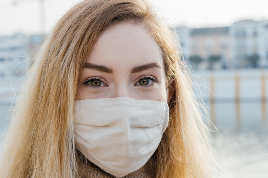 Woman in protective mask in city