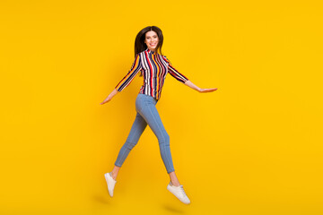 Fototapeta na wymiar Full body profile side photo of young woman happy positive smile go walk jump up air isolated over yellow color background
