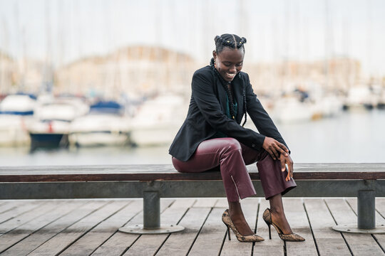 Cheerful black girl laughing sitting on bench