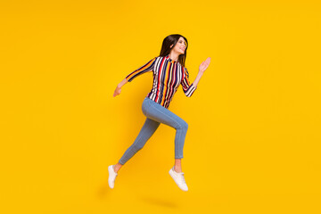 Fototapeta na wymiar Full size profile side photo of young woman happy positive smile jump go walk run hurry isolated over yellow color background
