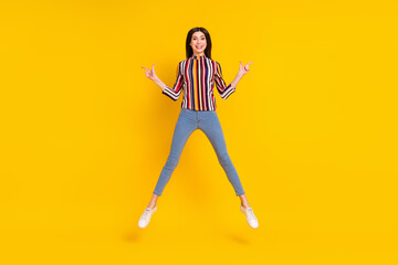 Fototapeta na wymiar Full body photo of young woman happy positive smile jump up point fingers empty space direct way ads isolated over yellow color background