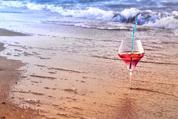 Wine glass with a cocktail by the sea.