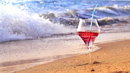 Wine glass with a cocktail by the sea.