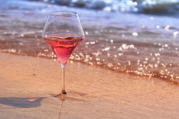 Wine glass with a cocktail by the sea.