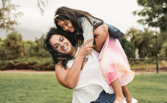 Happy Indian Mother Having Playful Time With Daughter At City Park - Family Love Concept