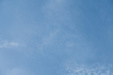 blue sky background with tiny clouds
