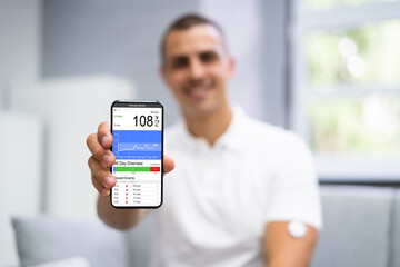 Man Using Continuous Glucose Remote Monitor