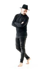 Unique style young man with hand and black turtleneck and jeans barefoot looking down. Full body portrait isolated on white background