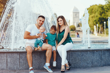 Cute family playing in a summer city