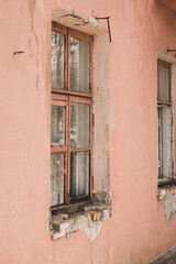 Fototapeta na wymiar Window Of Collapsed House In Town In Spring.