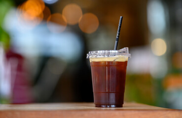 Cup of ice blackcoffee with light bokeh background