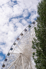 a big ferris wheel with colored cabins in the park