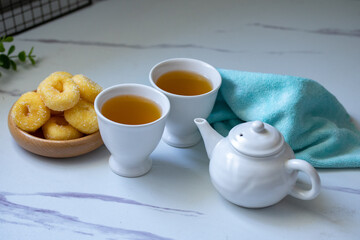 White ceramic tea set with donuts