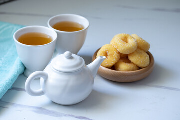 White ceramic tea set with donuts