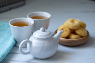 Obraz na płótnie Canvas White ceramic tea set with donuts