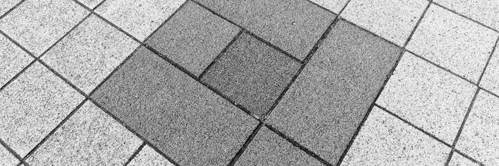 Obraz premium Light and dark gray paving stones in the driveway. Gray background