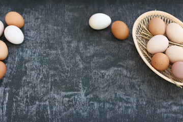 White and red brown eggs of domestic chickens in basket and Egg line on old wooden texture background. Natural eggs. Copy space, top view, flat lay