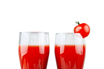 Two glasses with tomato juice and a small tomato on a white background.