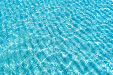 Obraz premium Background shot of aqua water surface. Swimming pool with sunny reflections.
