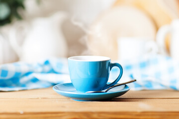 Obraz premium A clean blue cup in the kitchen. Mockup. Selective focus. Mock-up of a tea mug.