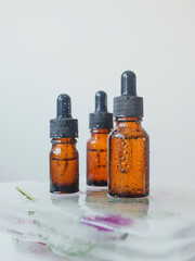 Brown glass bottle with serum, essential oil or other cosmetic product. Skin care concept.