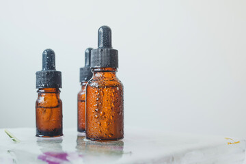 Brown glass bottle with serum, essential oil or other cosmetic product. Skin care concept.