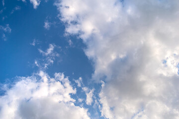 blue sky with bright white fluffy clouds by the sunlight