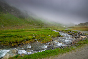 alpin river and misty mountains (Vorarlberg, Austria)