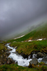 alpin river and misty mountains (Vorarlberg, Austria)
