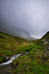 alpin river and a misty mountain scenery (Vorarlberg, Austria)