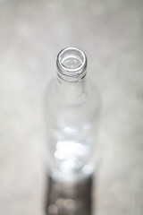 Clear empty glass bottle neck close up shot shallow depth of field top view