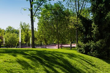 Landscape with green grass, evergreens, playgrounds and sports grounds in Public Landscape City Park 
