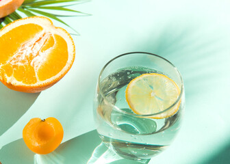 fresh summer fruit and water galss on blue background