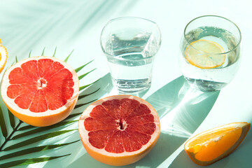 fresh summer fruit and water galss on blue background