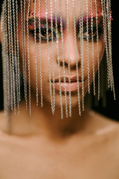 Stylish ethnic woman in creative African headpiece in studio
