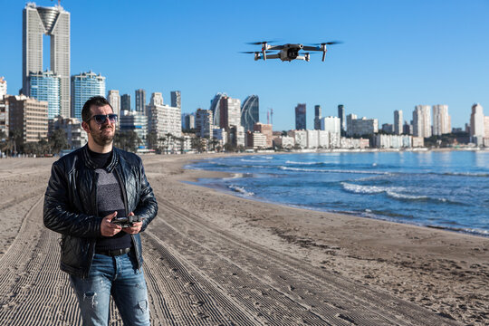 Man operating drone on the beach