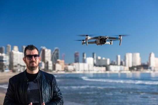 Man operating drone on the beach