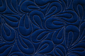 Close up texture of quilting by free-motion machine technique. on dark blue clothes Background