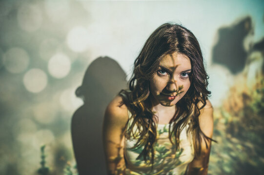 Young woman against field projection