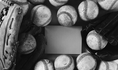 Baseball group of grunge balls in black and white flat lay with note card on background.