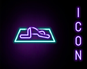 Glowing neon line Muslim man prays on the carpet icon isolated on black background. Colorful outline concept. Vector