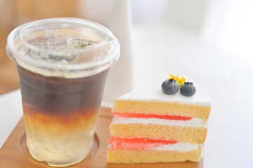 Black coffee and White cake on the wood table