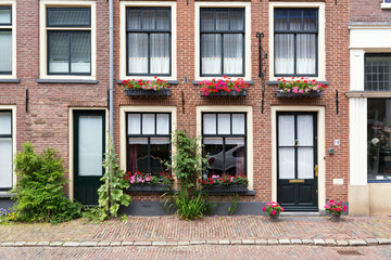 Fototapeta na wymiar Authentic colorful brick house fronts - facades in the historical center of Delft, The Netherlands