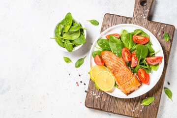 Salmon fillet with fresh salad. Healthy food, keto diet. Healthy lunch or dinner. Top view at white.