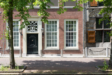 Authentic colorful brick house fronts - facades in the historical center of  Delft, The Netherlands