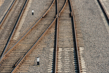 View of the railway from above. New modern railway with concrete piles and rubble. The intersection of rail tracks on the same level. Three rows of railway tracks