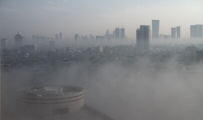 Heavy fog in Tel Aviv. Panorama above. The city over the clouds